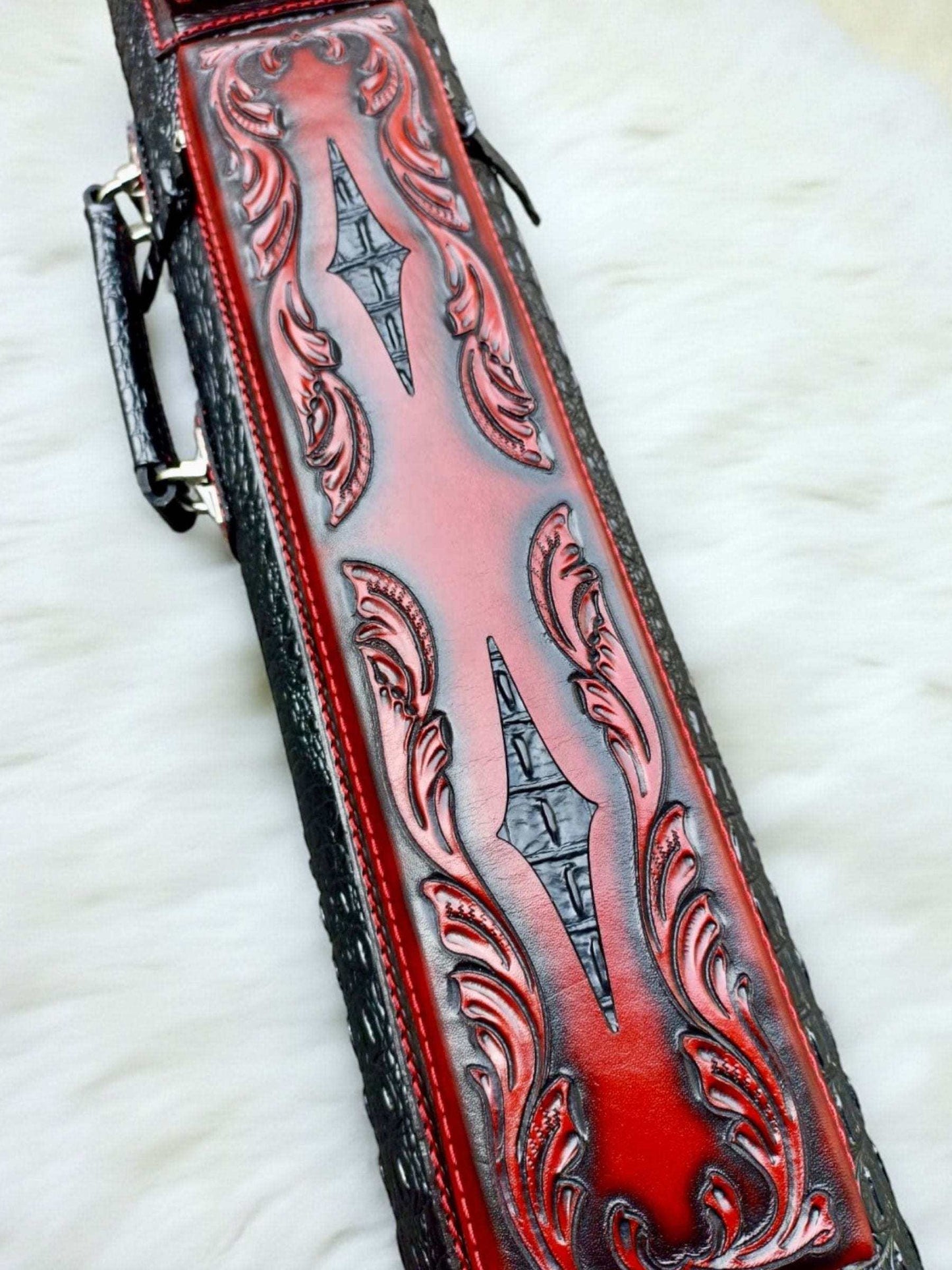Front close-up view of the red and black Throne Crocodile cue case in vegetable-tanned cowhide with a crocodile-embossed body.