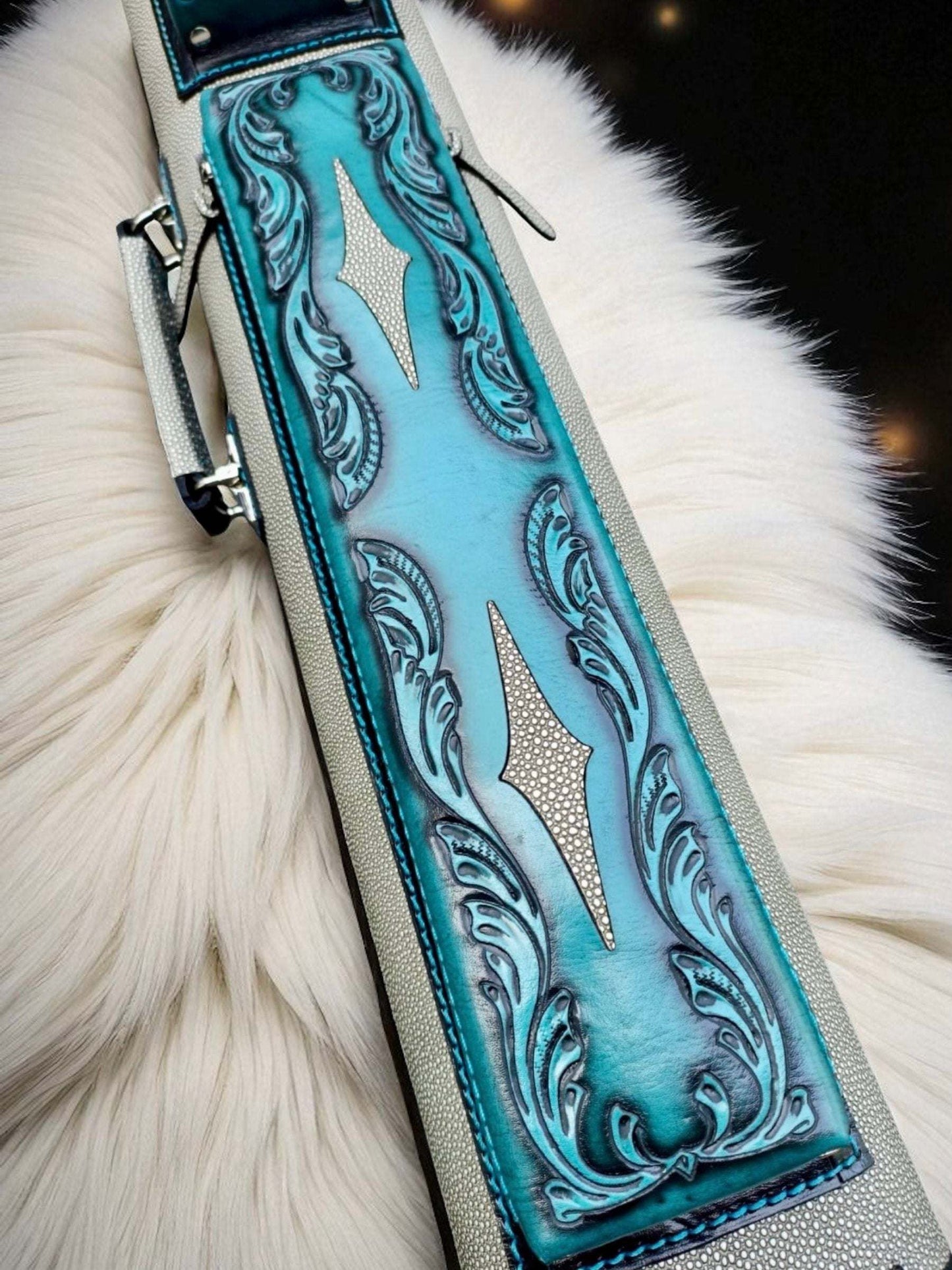 Close-up of Throne Stingray turquoise leather cue case with stingray leather detailing