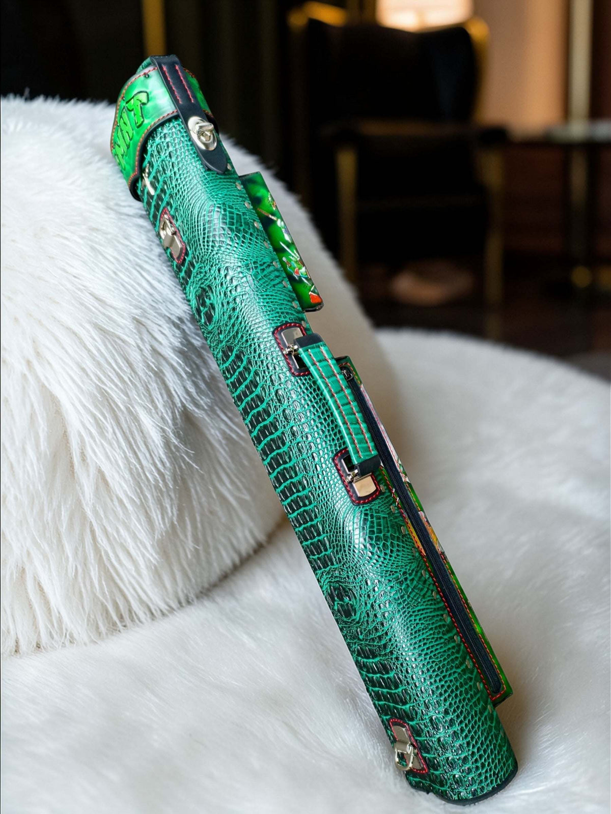 Side view of TMNT leather cue case showing custom green leatherwork, handle, and red accents