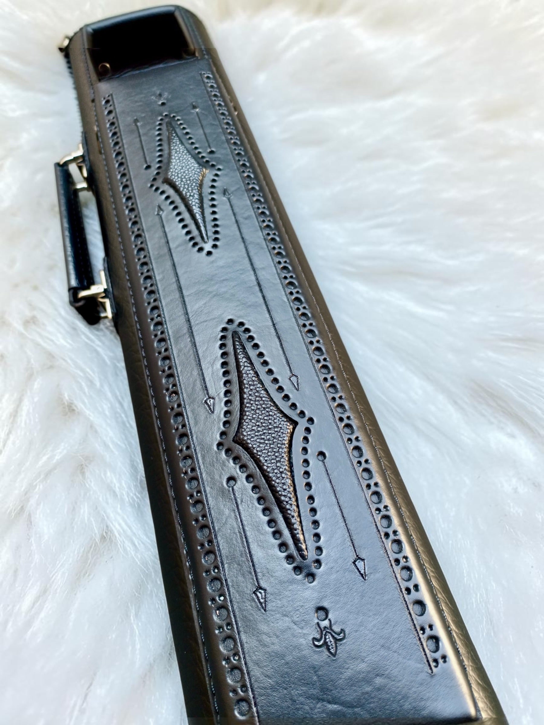 Close-up of Brogue I Ghost black leather pool cue case with hand-tooled tonal detailing