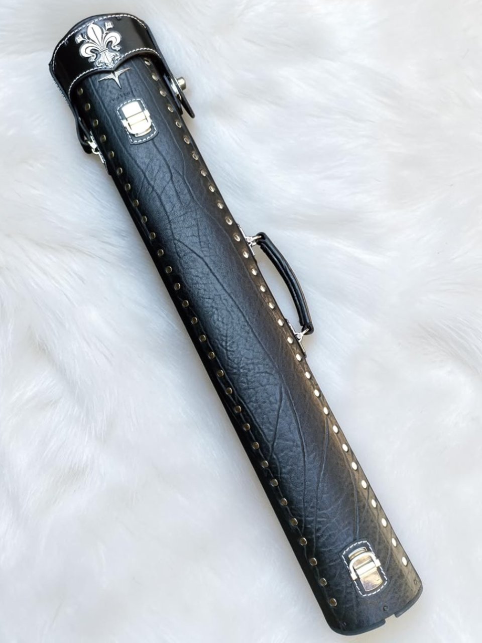 Back view of Crusade black leather cue case with hand-carved fleur-de-lis detail on the top lid and handmade finish