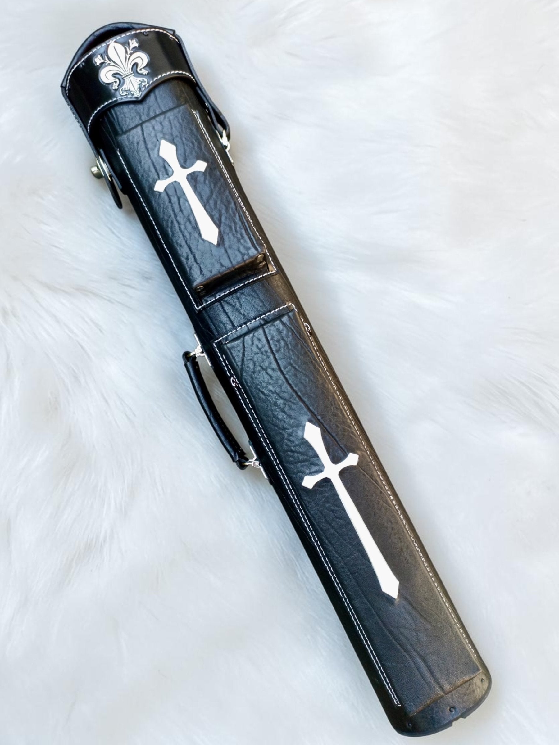 Front view of Crusade black leather cue case with white cross inlays, fleur-de-lis cap, and handmade finish