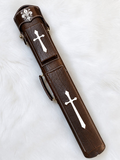 Front view of Crusade brown leather cue case with cross inlays, fleur-de-lis detailing, and handmade finish