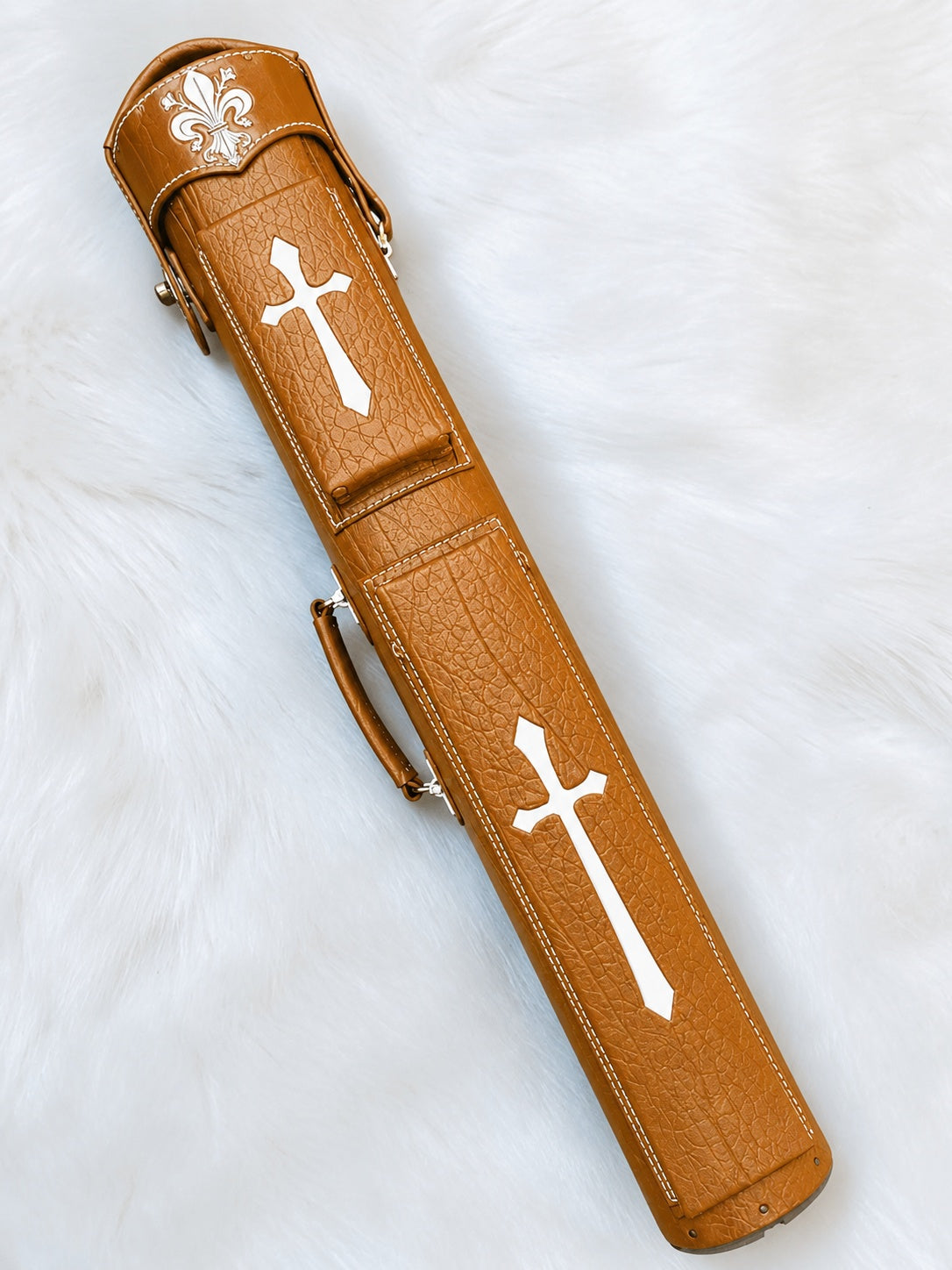 Front view of Crusade tan leather cue case with cross inlays, fleur-de-lis detailing, and handmade finish