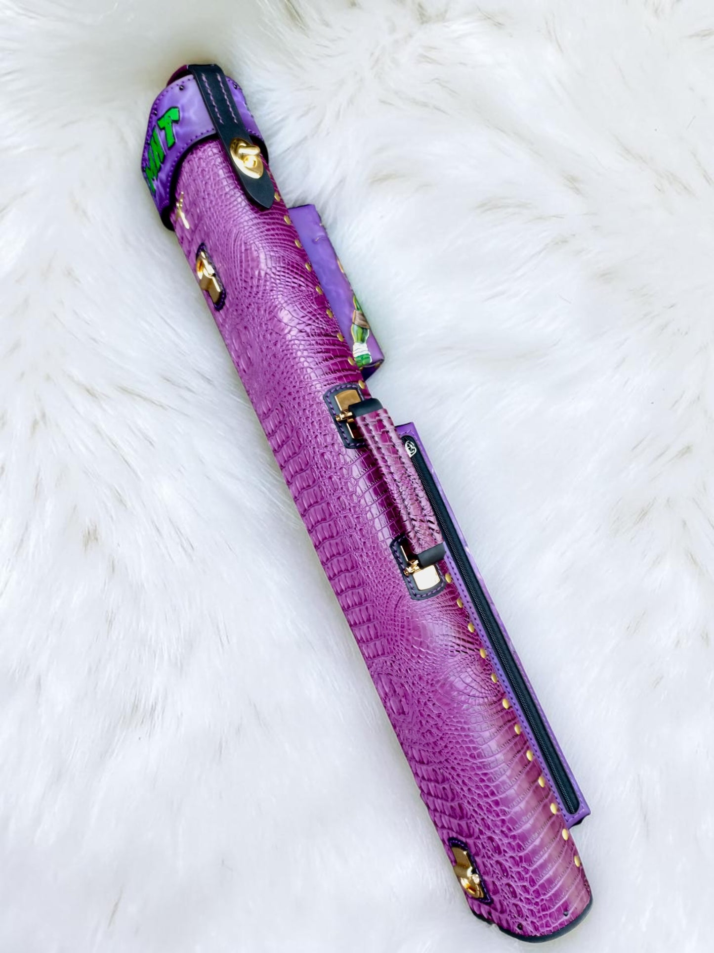 Side view of TMNT Donatello leather cue case showing purple crocodile embossed leather, handle and zipper