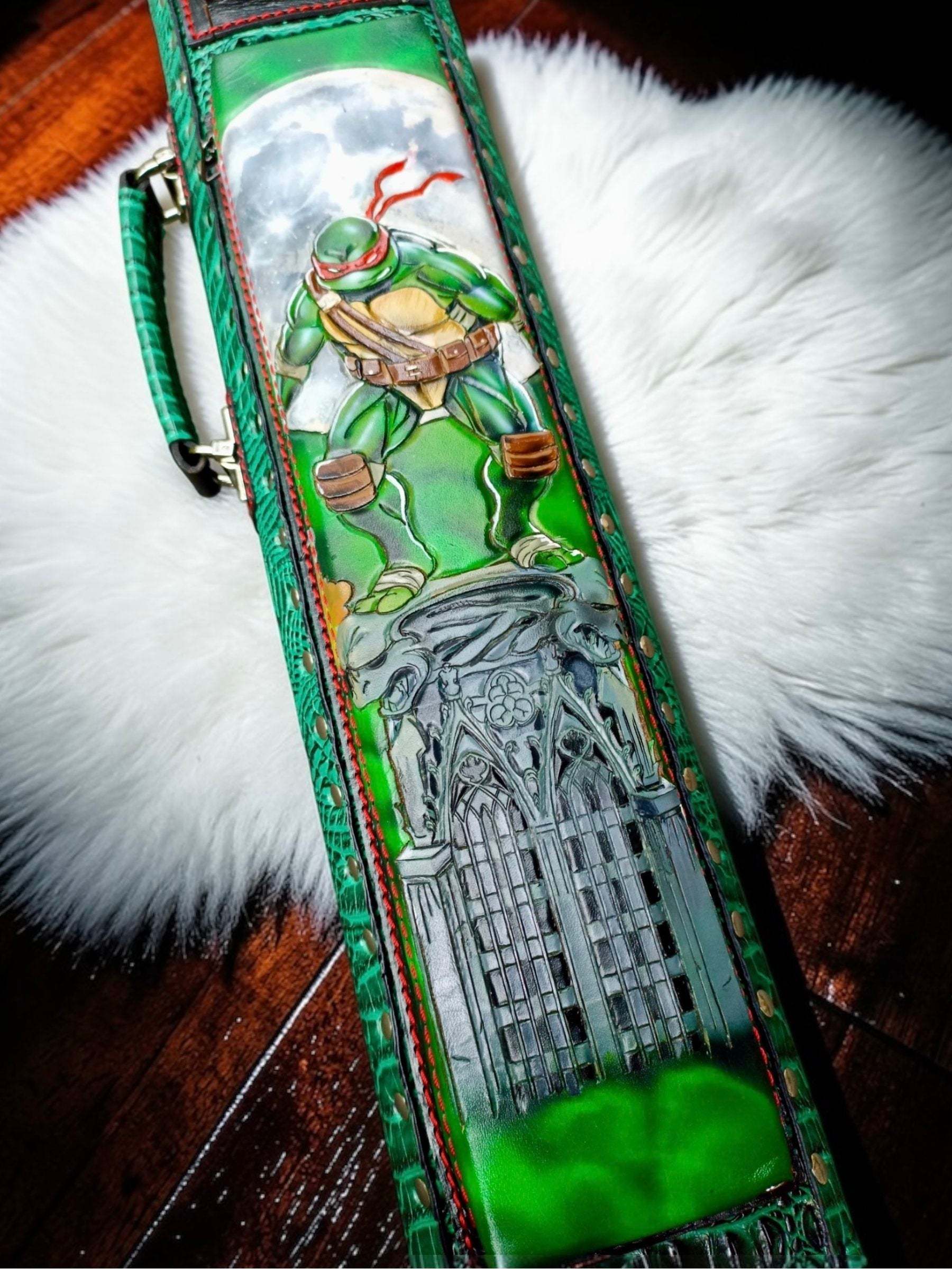 Detailed close-up of TMNT leather cue case with character artwork and fine handmade leatherwork